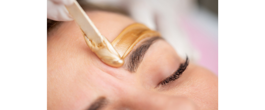 salon express services - a woman getting an eyebrow wax